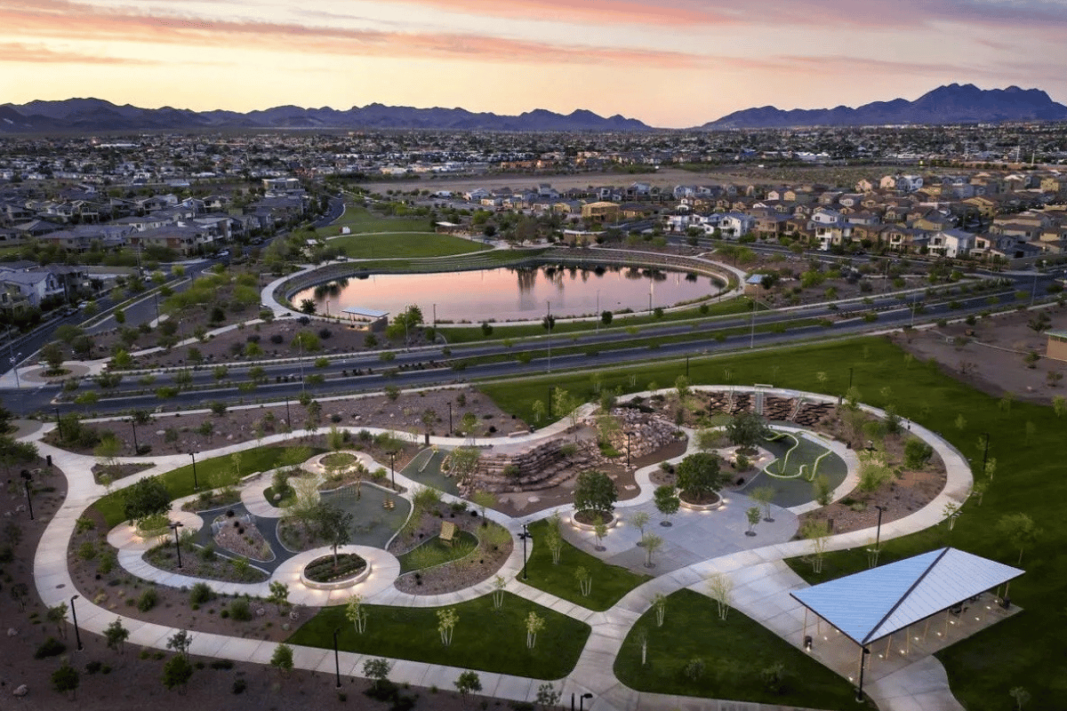 An aerial view of the master planned community of Cadence, featuring Central Park, which provides a children’s play area, picnic tables, and a path around the pond.
